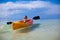 Little cute girl rowing a boat in clear sea