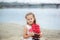 Little cute girl and scarlet sails. Close-up portrait of the girl`s face. little girl wait boat with scarlet sail. Summer day. Hap