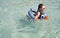 Little cute girl swims in sea.