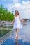 Little cute girl walking in open street fountain