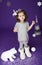 Little cute girl in white winter wreath and with toy polar bear having fun in studio on purple background with silver Christmas