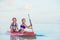 Little cute girls swimming on surfboard during