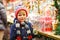 Little cute kid boy buying sweets from a cancy stand on Christmas market. Happy child on traditional family market in