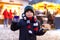 Little cute kid boy eating German sausage and drinking hot children punch on Christmas market. Happy child on