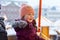 Little cute kid girl having fun on ferris wheel on traditional German Christmas market during strong snowfall.