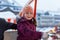 Little cute kid girl having fun on ferris wheel on traditional German Christmas market during strong snowfall.