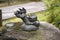 Little cute playful jumping dragon statue on a stone inspiring zen buddhist artwork found at a public park in Fukuoka Japan