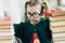 Little cute scientist girl portrait with glasses and books