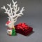 Little cute snowman, white tree, red gift box with ribbon.