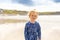 Little cute toddler girl at the Ballybunion surfer beach, having fun on surfboard for the first time, west coast of