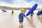 Little cute toddler girl at the Ballybunion surfer beach, having fun on surfboard for the first time, west coast of