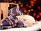 Little cute white puppy Shiba inu sleeps on a colored knitted sweater