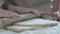 Little daughter carefully rolling dough, helping her mother in dinner cooking