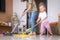 little daughter cleaning in the house, child dusting, Cute little helper girl washing floor with mop, happy family
