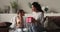 Little daughter congratulates mom gives her gift box