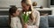 Little daughter gives tulips to mom congratulates her on birthday
