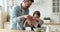 Little daughter helping father making dough for pancakes in kitchen