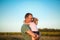 Little daughter hugs father tightly around the neck