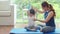 Little daughter looking her mother during learning yoga