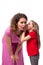 Little daughter whispers her secret to her mother in her ear, and her mother reacts emotionally to it. Warm and friendly family