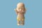 Little doll toy on blue background is isolate