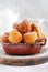 Little Donuts. Homemade curd fried cookies in deep fat and sprinkled with icing sugar in a vintage plate on a light background.