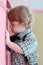 Little dreaming boy looks into cabinet