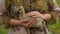 Little duckling sits on the hands of a farmer