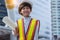 Little engineer boy wear protective helmet and holding document wearing protective workwear.  Smart adorable kid learning outdoors