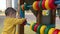 Little excited happy toddler boy playing with colorful abacus circle on children's playground outside. True feelings