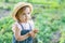 Little farmer child - lovely girl with picked vegetables