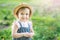 Little farmer child - lovely girl with picked vegetables