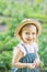 Little farmer child - lovely girl with picked vegetables