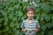 Little Farmers holding big basket with harvest of fresh homemade cucumbers. Organic vegetables.