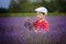 Little fashionable boy having fun in lavender field