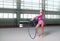 Little female gymnast posing with hoop