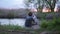 Little fisherman, children brothers sit on pier and fish with a fishing rod in river on sunset on outdoors amid cane