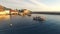 The little fishing boats stand on a dock near the old Greek town.