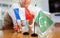 Little flag of Pakistan on table and flag of France put next to it by young woman