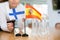 Little flag of Spain on table and flag of Finland put next to it by young woman