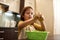 Little focused girl looking on hands with dough