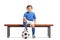 Little footballer sitting on a wooden bench