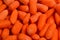 Little fresh carrots as a background. Snack