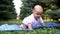 Little funny baby crawling on the grass.