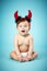 Little funny baby with devil horns