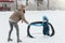 Little funny boy with her mother skating in the park. Play ice hockey with stick and goal. Outdoor. Winter sport