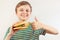 Little funny boy recommends and likes big hamburger on white background