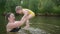 Little funny cute blonde girl child toddler in yellow bodysuit laughing learns swim outside at summer lake. Plus size