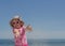 Little funny girl 3 years old on the beach throws sand. Blurre