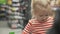 Little funny girl rides a trolley in a supermarket